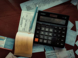 a calculator sitting on top of a wooden table